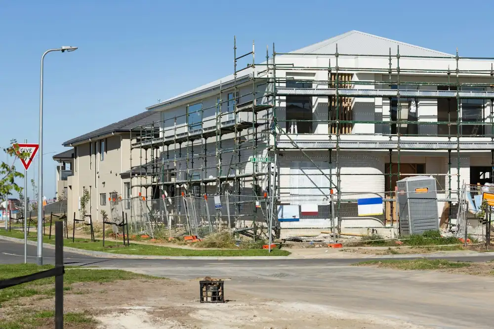 Two-storey house wrapped in scaffolding in a new Australian housing estate